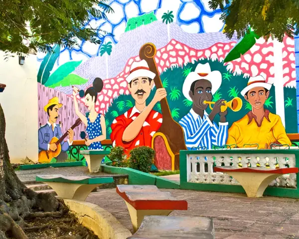 Kolorowy mural przedstawia muzyków grających na instrumentach, jakby na ulicy stolicy Kuby.