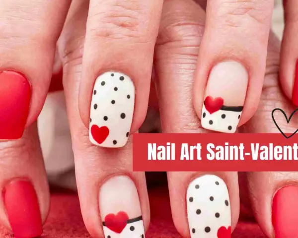 Manucure festive pour la Saint-Valentin : ongles rouges unis et ongles blancs à pois noirs et cœurs rouges.