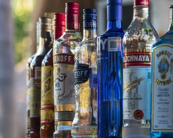 Rząd butelek alkoholu, w tym Smirnoff i Bombay Sapphire, sugeruje ceny alkoholu na Cyprze.