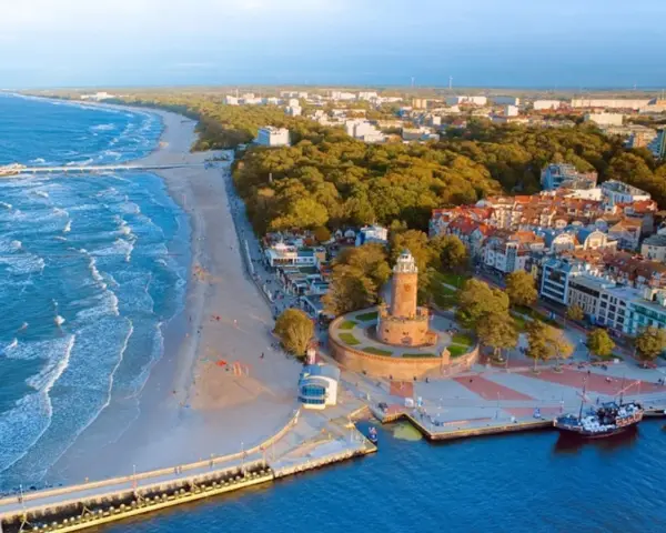 Idealne miejsce, gdzie nad morze. Widok na plażę, molo, latarnię i nadmorskie miasteczko.