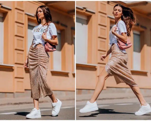 Kobieta w błyszczącej spódnicy i białej koszulce prezentuje miejski styl. Jej stylizacja to kwintesencja street fashion.