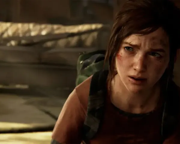 Ellie, con el rostro sucio y herido, busca en una **caja fuerte de hotel** en The Last of Us.