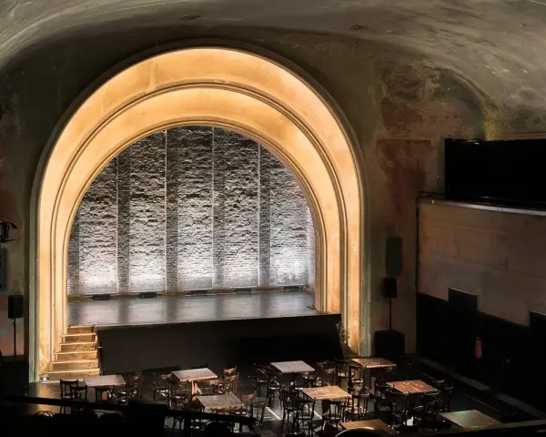 Das **Theater im Delphi** mit seiner beeindruckenden Bogenarchitektur und der beleuchteten Bühne lädt zu unvergesslichen Vorstellungen ein.