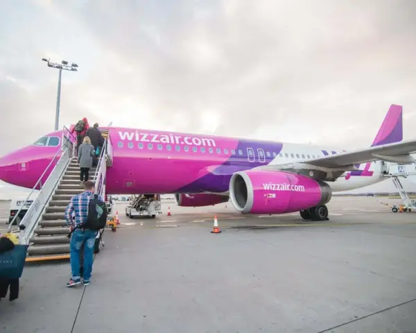 Pasażerowie wsiadają do różowego samolotu Wizzair. Czy można odwołać lot?