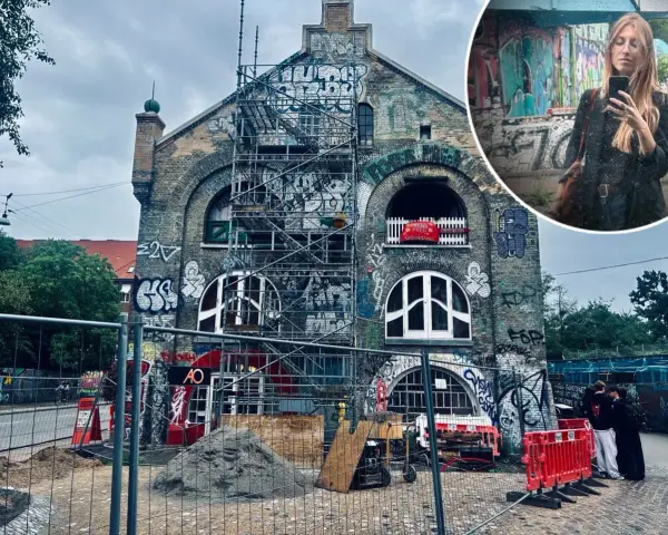 Kopenhaga nietypowe miejsca: zrujnowany budynek z graffiti i rusztowaniami, w tle kobieta robiąca selfie.
