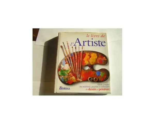 Le livre "L'Artiste" de Bordas, un guide pour devenir artiste auteur, avec une palette de peintre et des pinceaux.