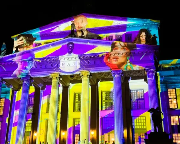 Das Konzerthaus Berlin erstrahlt in bunten Farben bei der "Berlin Nacht der Lichter". Gesichter und Muster projiziert auf die Fassade.