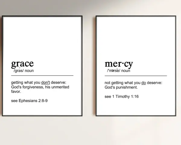 Two framed prints define "grace" as unmerited favor and "mercy" as not getting what you deserve, illustrating the contrast between grace vs mercy.