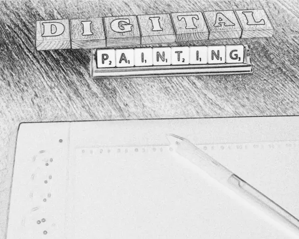 Drewniane klocki z literami układają się w napis "DIGITAL PAINTING". Obok leży pióro i notatnik, sugerując rozpoczęcie kursu.