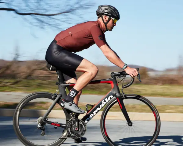 Cyclist in motion, demonstrating optimal road bike seat height for efficient pedaling.