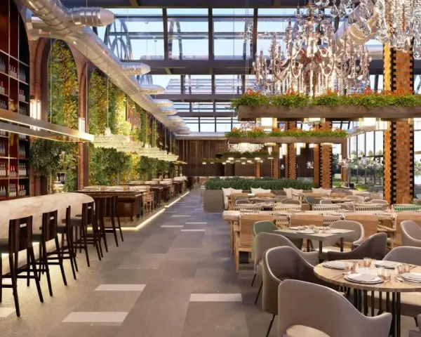 Interior de restaurante moderno con bar, mesas y vegetación. Un lugar elegante para pensar cuanto cuesta abrir un restaurante.