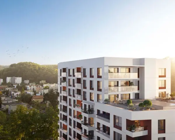Nowe inwestycje Gdynia: nowoczesny apartamentowiec z tarasami i widokiem na zieleń.