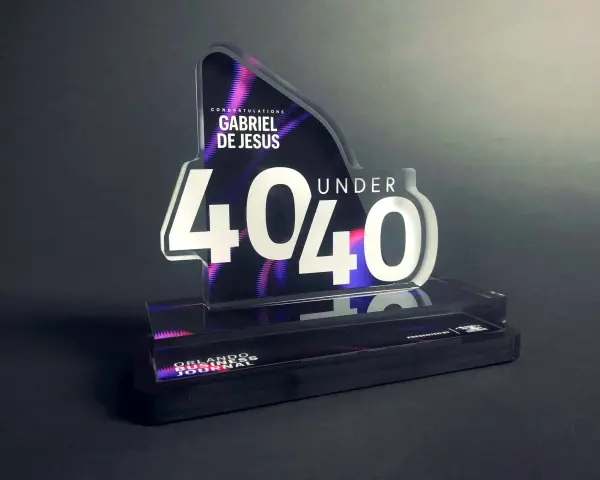 A "40 Under 40" award for Gabriel De Jesus, showcasing how strong is acrylic. The award features a sleek, modern design with vibrant purple and pink accents.