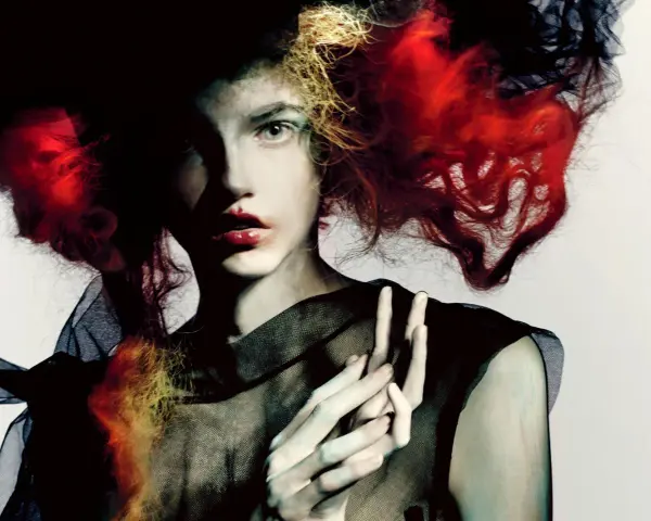 Portret kobiety z ognistymi włosami i czarną siatką, w stylu Paolo Roversi.