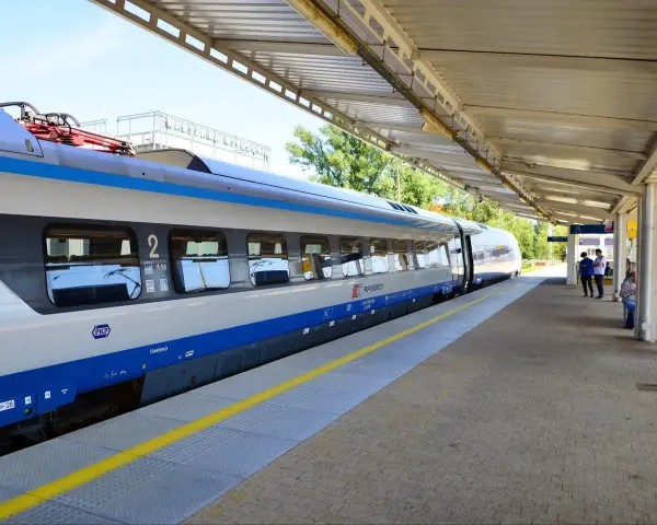 Pociąg PKP Intercity TLK czeka na pasażerów na peronie.