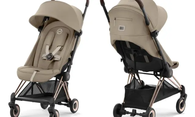 Elegancki wózek spacerowy Cybex w kolorze beżowym, z brązową rączką i złotymi elementami. Idealny na spacery.