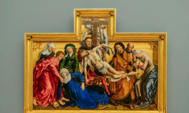 A dramatic religious painting, likely from a museum, depicts the descent from the cross with figures in rich robes surrounding a fallen Christ.