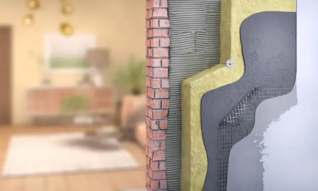 Corte de pared que muestra el aislamiento y la mampostería, parte de un sistema passivhaus para eficiencia energética.