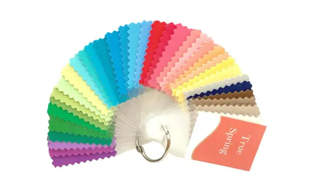 A fan of fabric swatches in various bright colors, with a tag reading "True Spring".