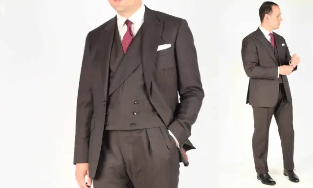 A man in a dark pinstripe suit, white shirt, and red patterned tie. He's adjusting his cuff, ready for a formal event.