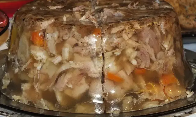 Pyszna galareta wieprzowa z kawałkami mięsa i warzyw, przygotowana na specjalną okazję.