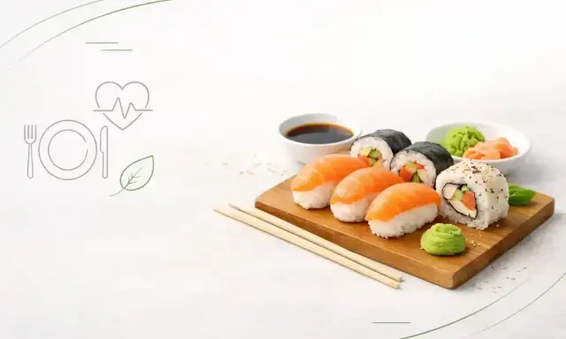 Czy sushi jest zdrowe? Na talerzu nigiri z łososiem, rolki maki z ogórkiem i awokado, sos sojowy, wasabi i imbir. Obok ikony serca z pulsem i liścia.