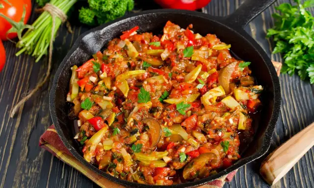 Poêlée de légumes colorée, une spécialité Côte d'Azur, avec courgettes, poivrons et tomates, garnie de persil frais.