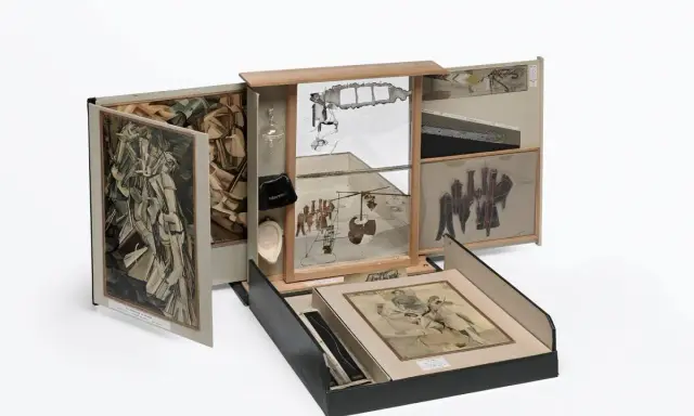 A surreal assemblage of famous drawers, featuring collage, mirrors, and found objects, creating a miniature world of artistic exploration.