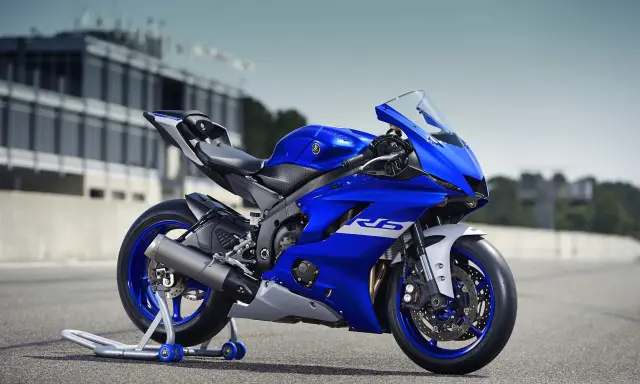 Niebieski motocykl sportowy Yamaha YZF R6 na torze wyścigowym, gotowy do akcji.