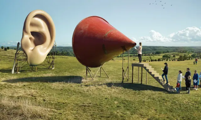 A surreal landscape by Erik Johansson photography. A giant ear stands next to a red megaphone, with people climbing stairs towards it.