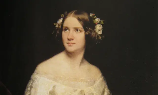 Porträtt av en ung kvinna med blommor i håret, kanske en ung Jenny Lind.