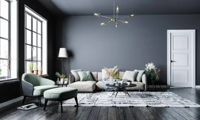 Nowoczesny salon z szarą ścianą, beżową kanapą i miętowym fotelem. Inspiracje kolory dla Twojego wnętrza.