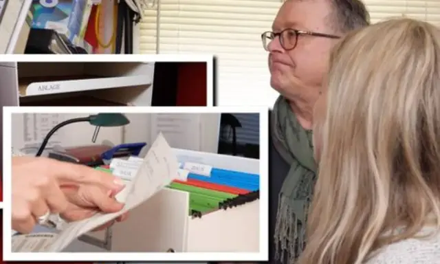 Mann und Frau sortieren Dokumente, um das Arbeitszimmer zu organisieren. Ordner und Ablagefächer sind sichtbar.