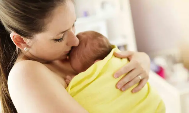 Un tenero abbraccio tra madre e neonato, un esempio di attaccamento alla madre psicologia, che crea un legame indissolubile.