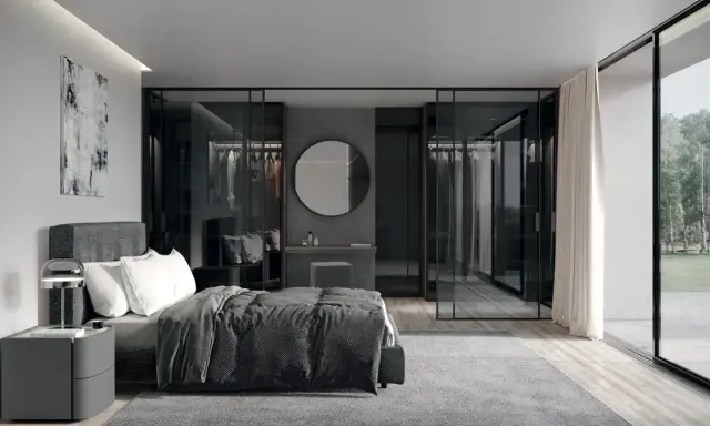 Elegante camera da letto con letto grigio scuro, abbinamenti moderni e cabina armadio a vista.