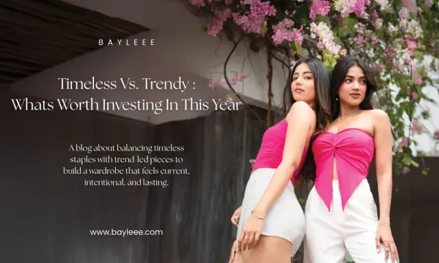 Two women showcase modern fashion couture, one in a pink tube top and white shorts, the other in a pink knotted top and white pants, against a backdrop of pink flowers.