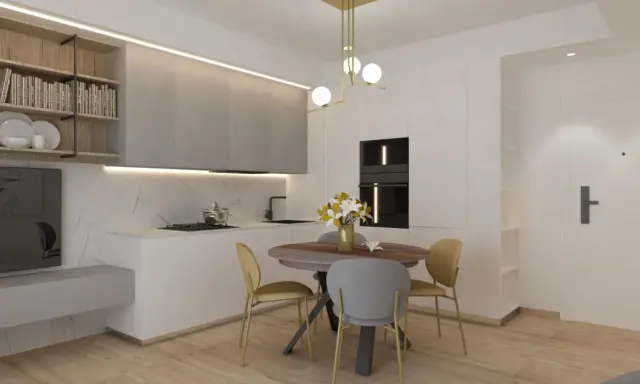 Ingresso su sala da pranzo con tavolo rotondo, sedie, cucina moderna e scaffali a muro.
