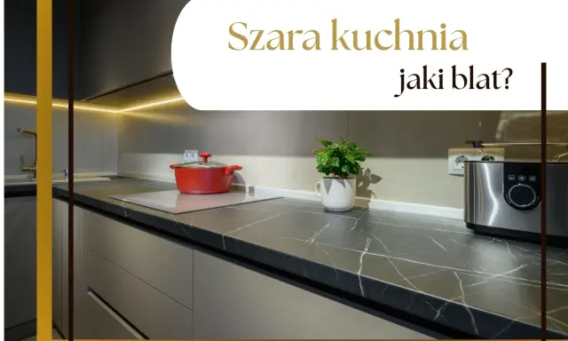 Nowoczesna szara kuchnia z ciemnym blatem, na którym stoi czerwony garnek i srebrny toster.