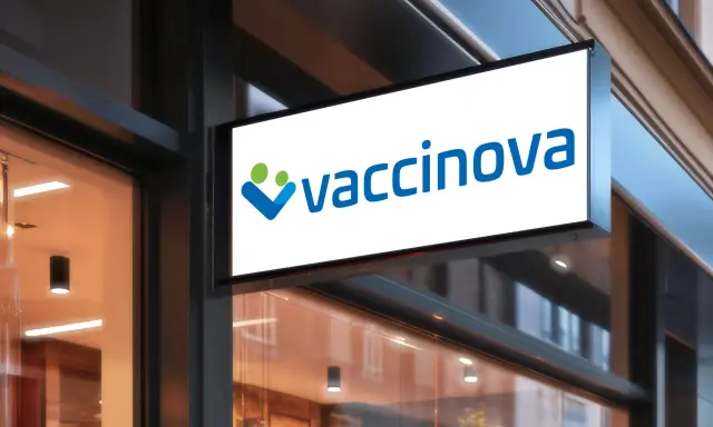 Belyst skylt med logotypen "vaccinova" och två stiliserade figurer, en grön och en blå. Företaget fokuserar på vaccin i Asien.