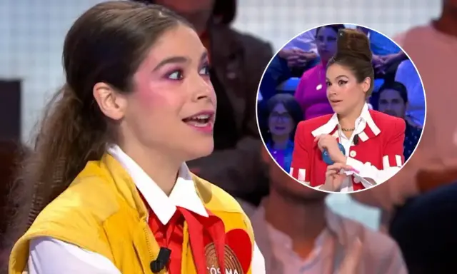 Cosima Ruiz de la Prada, con maquillaje llamativo y un chaleco amarillo, habla en un programa. En un círculo, se ve su peinado alto y chaqueta roja.