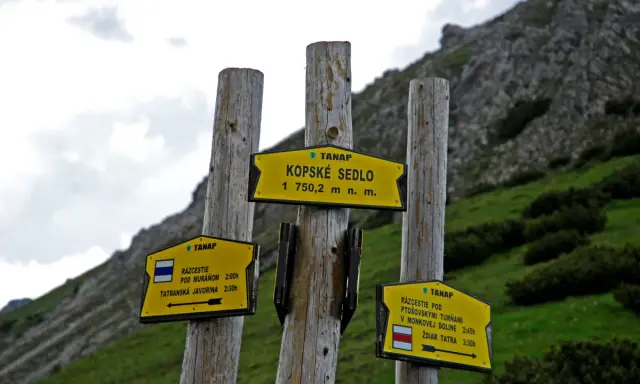 Rozcestník v Tatrach Bielskich. Znaki wskazują drogę na Kopské sedlo (1750 m n.p.m.), Pod Muráň, Tatranską Javorinę, Ptoszowskie Turnie i do Żdziaru.