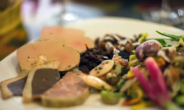 Assiette de foie gras et confit, salade colorée. Un aperçu des spécialités Nouvelle Aquitaine.