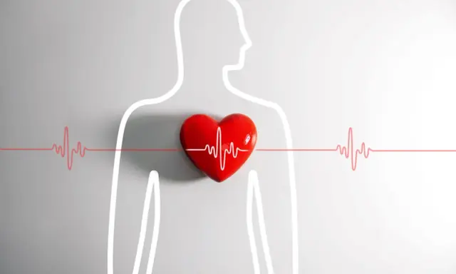 Czerwone serce z linią EKG symbolizuje problemy z rytmem serca, jak arytmia, która może być pogłębiona przez alkohol.