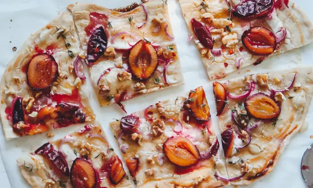 Flammkuchen mit Pflaumen, Zwiebeln und Walnüssen. Ein köstlicher Flammkuchen Belag, der süß und herzhaft kombiniert.