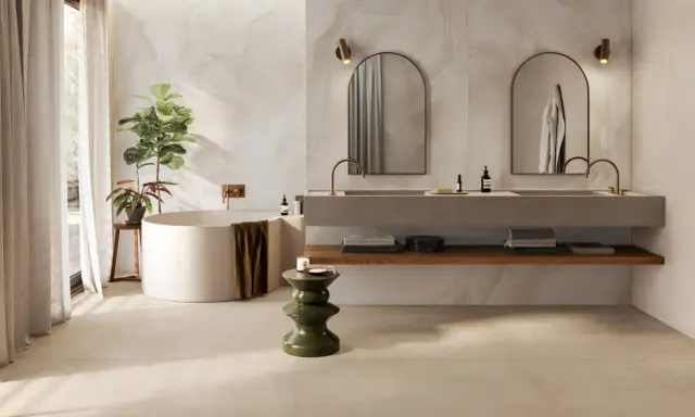 Baño moderno con bañera exenta, lavabos dobles y azulejos a matajunta en paredes y suelo.