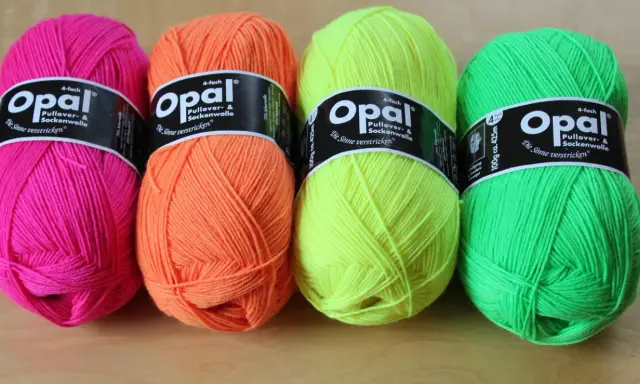 Four balls of Opal yarn in bright pink, orange, yellow, and green.