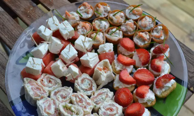 Enkla snittar till många: laxrullar, fetaost med vattenmelon, jordgubbar med grädde och räknyheter. Perfekt för festen!