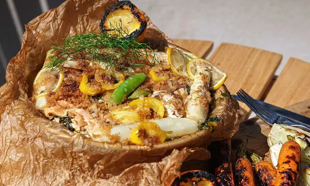En saftig fisk i foliepaket med citron, sparris och dill. Serveras med grillade rotfrukter.