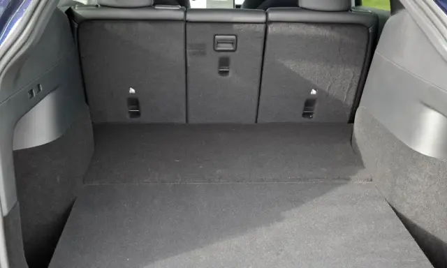Leerer Tesla Model Y Kofferraum mit umgeklappten Rücksitzen. Viel Platz für Gepäck oder Einkäufe.