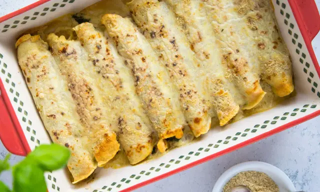 Zapiekane naleśniki z pysznym farszem, polane sosem i posypane serem, gotowe do podania.